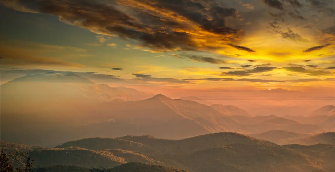 Layered mountain ranges at sunset above the idle valley