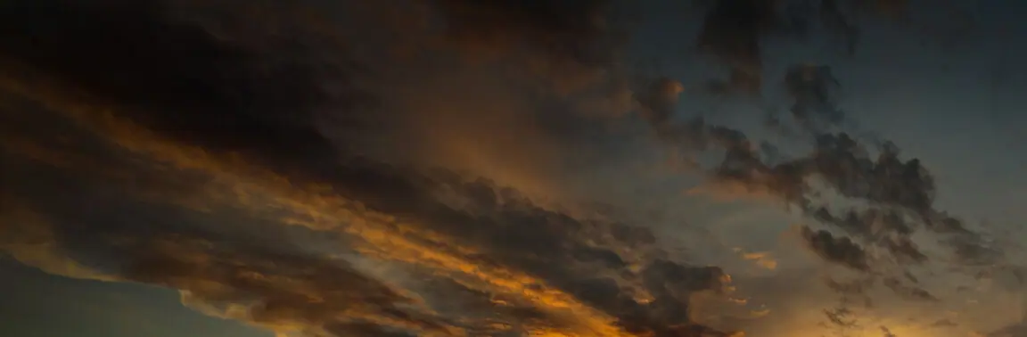 Sunset cloud bands over the mountain range